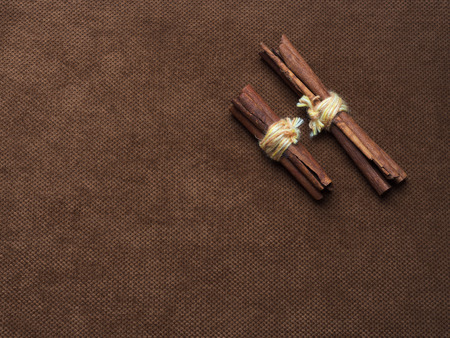 Cinnamon sticks tied with string. On a nice brown background with a place for the inscription on the...