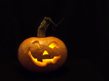 Smiling head made of pumpkin. A real fire. Holiday Halloween.の写真素材