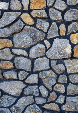 Background of large stones collected in a mosaic. The distance between the elements is filled with cement.の写真素材