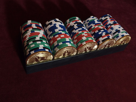 Bitcoi coins with poker chips on red cloth. The concept of replacing bitcoin with all payment...