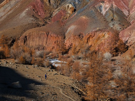 Fantastic Martian landscape. A small silhouette of a girl against a background of huge mountains.
