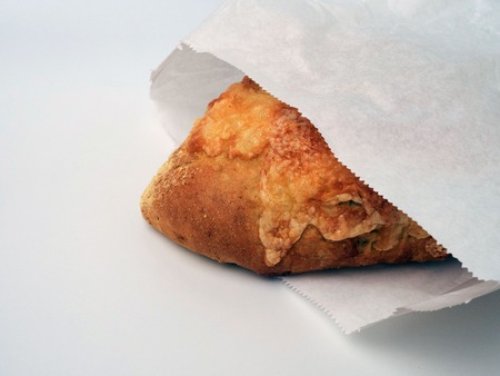 Cheese bread, packed in a paper bag, isolated on white.の写真素材