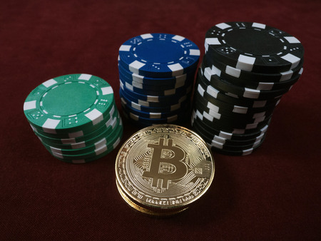 Bitcoin coins and poker chips. New virtual and real currency. The concept of replacement bitcoin in...