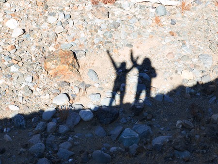 Silhouette of people greeting you over natural background at the mountain. Celebration success happiness on a mountain top. Sport and active life concept, with clipping path.の写真素材