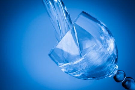 The blue goblet pouring with splashing waterの写真素材