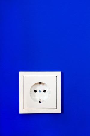 Electrical outlet on blue painted wallの写真素材