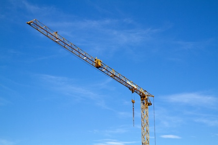 Tower construction crane isolated against blue skyの写真素材