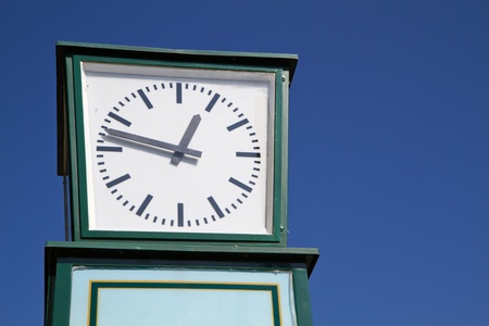 Old city (station) clock isolated against blue sky