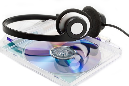Compact Discs (CDs) with headphones on white