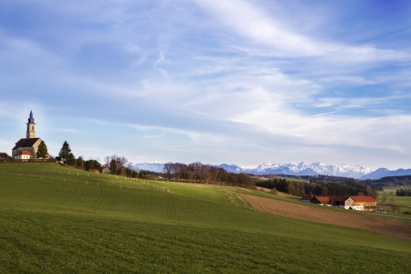 Typical bavarian church with view to the alpsの写真素材