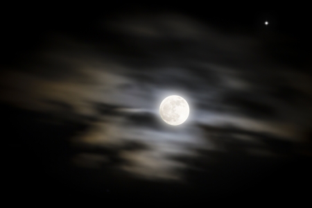 Full moon with one star and dramatic skyの写真素材