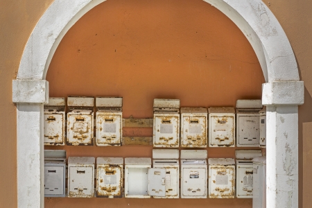 Old rusty metal mailboxes, seen in Greeceの写真素材