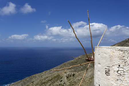 Old windmill overlooking the sea on Karpathos, Greeceの写真素材