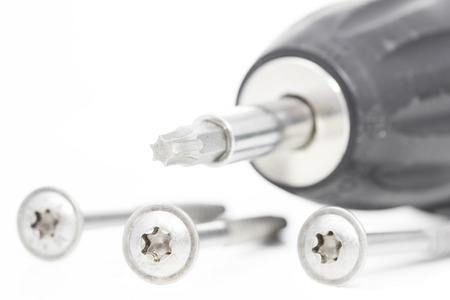 Cordless screwdriver with screws on white