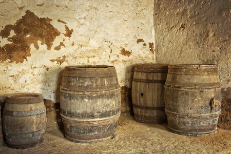 Old wine barrels in a cellarの写真素材