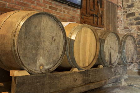 Old wine barrels in a cellarの写真素材