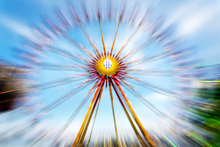 Big wheel on a fun fare, shot taken with intentional camera movement (ICM)の写真素材