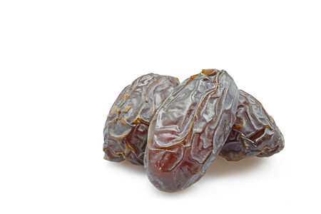 Three dried dates isolated on whiteの写真素材
