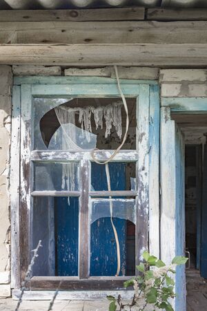 Window with broken glass on an abandoned home in the exclusion zone of Chernobyl in Belarus...