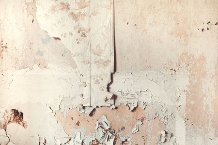Weathered old wallpaper on a wall as background