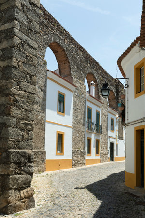 Residential buildings integrated into the Evora aqueduct, Portugal