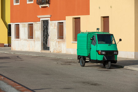 Small green commercial vehicle in Italy
