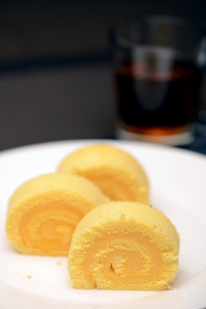 Jam roll cake and hot teaの写真素材