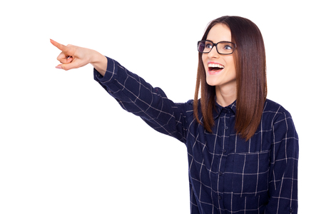 Look at that! A beautiful woman pointing upwards and away over a white backgroundの写真素材
