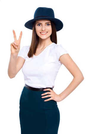 Youth for peace. Studio portrait of an attractive young woman giving the peace sign isolated on whiteの写真素材