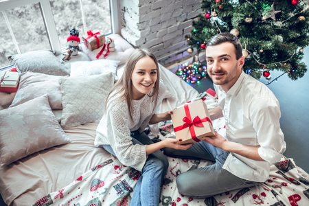 Merry Christmas. Young couple celebrating Christmas at home. Top viewの写真素材