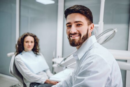 Portrait of a male dentist and young woman in a dentist office.の写真素材