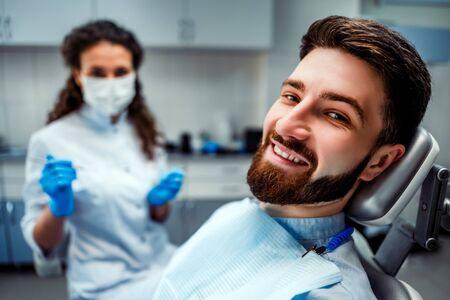 Portrait of happy patient in dental chair.の写真素材