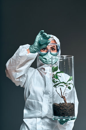 Medium shot of biologist working with plant incubators in a lab of a Mars base. Vertical photo