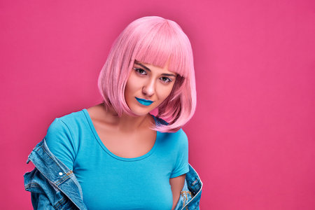 Fashion portrait of beauty young woman with pink bob hairstyle. Pink sunglasses. Beautiful girl isolated pink background. Copy spaceの写真素材