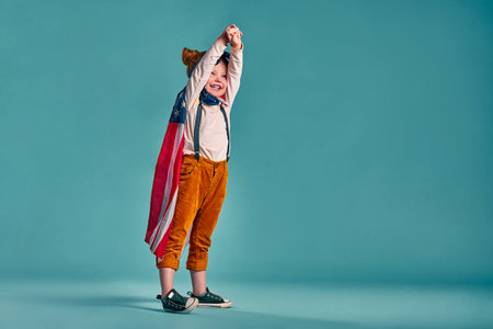 Patriotic holiday. Happy kid, cute little child girl with American flag. USA celebrate 4th of July. Copoy spaceの写真素材