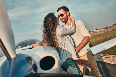 Couple in love hugging near private plane. Selective focusの写真素材
