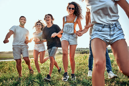 Group of friends having fun on the nature. Summer, holidays, vacation, happy people concept. Close up viewの写真素材