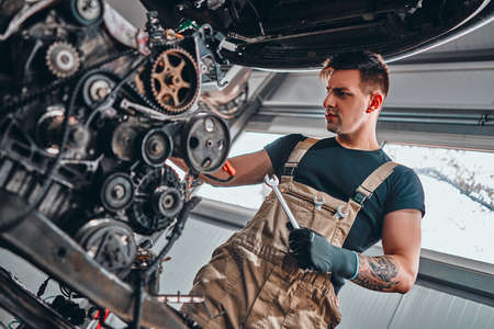 Car mechanic and car engine outside the vehicle. Low angle view. Selective focus.の写真素材