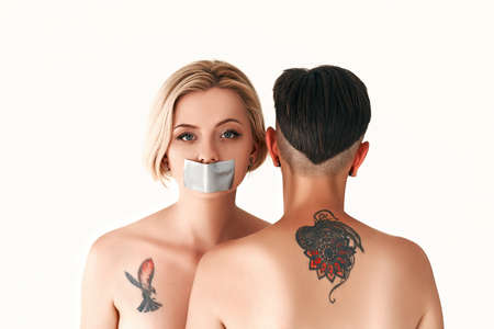 An attractive frightened naked lesbian with scotch tape in her mouth during censorship and freedom...