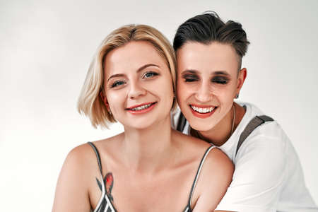 Two lesbian woman embracing and smiling on white background. Equality right, homosexuality...