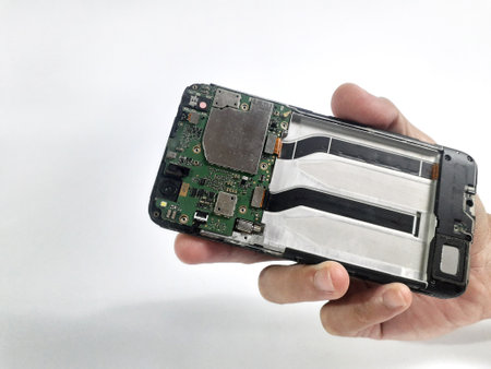 The back of the cellphone is being dismantled and the engine components are visible