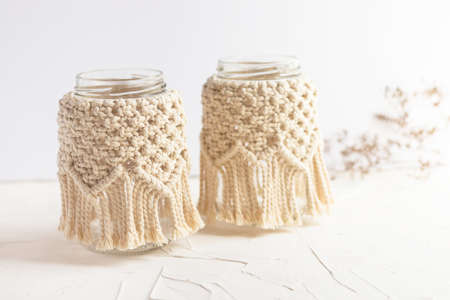 Small glass vases, two jars, candleholder with macrame cover. Dry herbs. Boho style. Bohemian home...