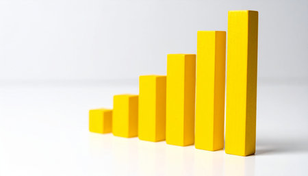 Yellow 3D bar graph isolated on white background. Growing business, success and improvement. Close-up.の素材