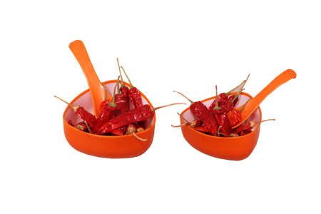 Dried Reddish Spicy Chilly in orange cup with spoonの写真素材