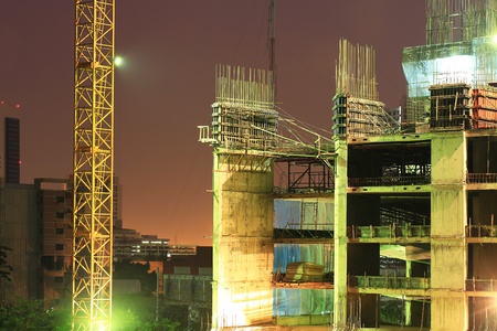 High rise concrete building construction with a yellow craneのeditorial素材