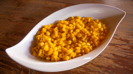 Creamy Corn Kernels in Elegant White Bowl, Restaurant Snack Menuの写真素材