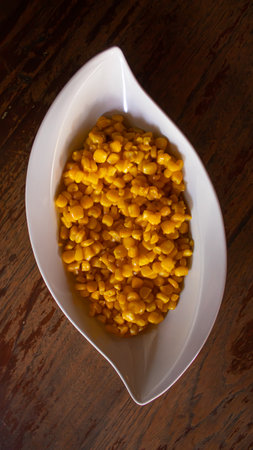 Creamy Corn Kernels in Elegant White Bowl, Restaurant Snack Menuの写真素材