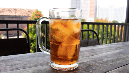 Sweet Iced Tea in Clear Glass on Wooden Table â€“ Refreshing Beverage Photo