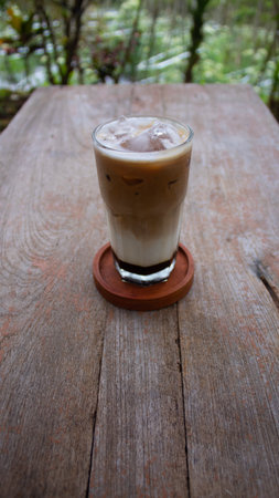 Iced latte coffee on wood table in coffee shop, stock photo