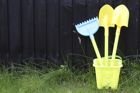 Kids Gardening Kit placed next to a black wooden wallの写真素材